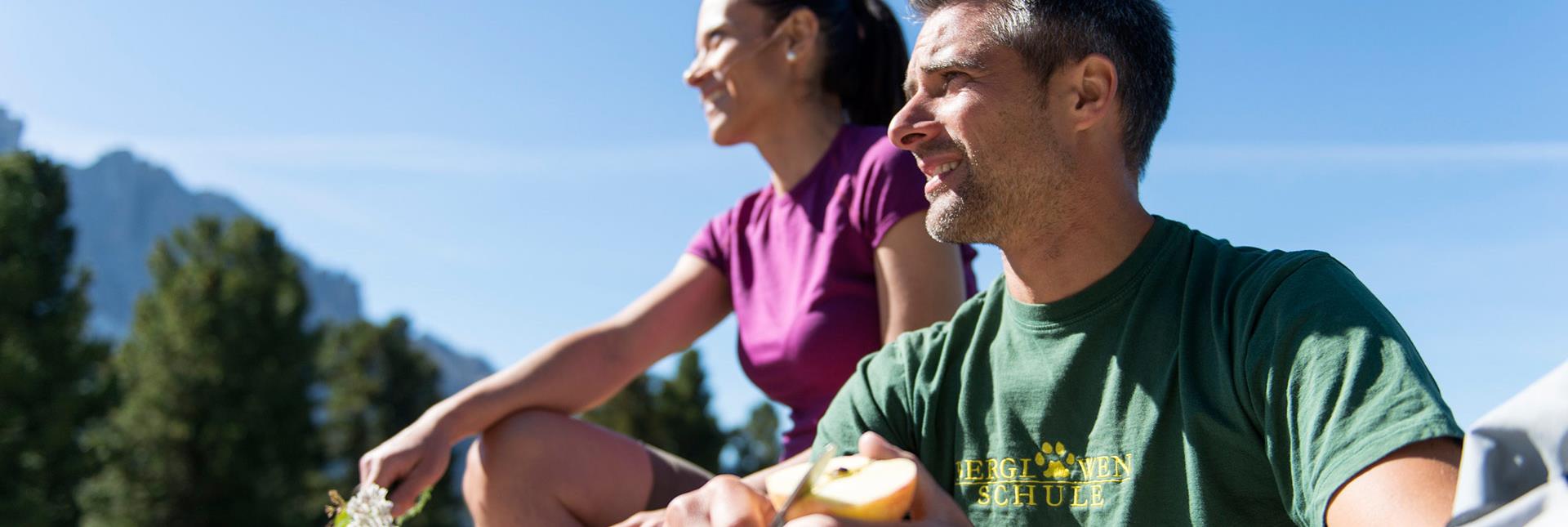 Two people sitting in the sun